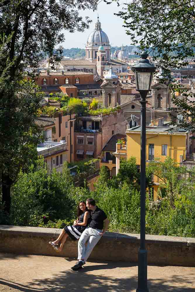 Couple leisurely on vacation enjoying the sun and the view from Parco del Pincio